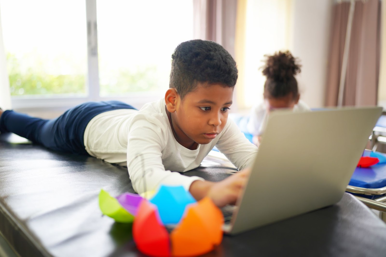 Children taking part in a virtual classroom game on a laptop